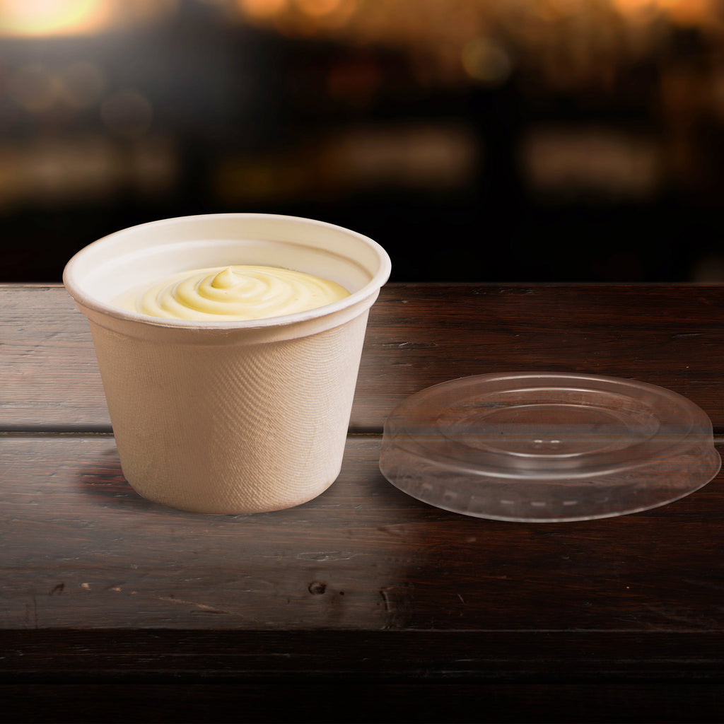 Compostable cup with lid on a wooden surface