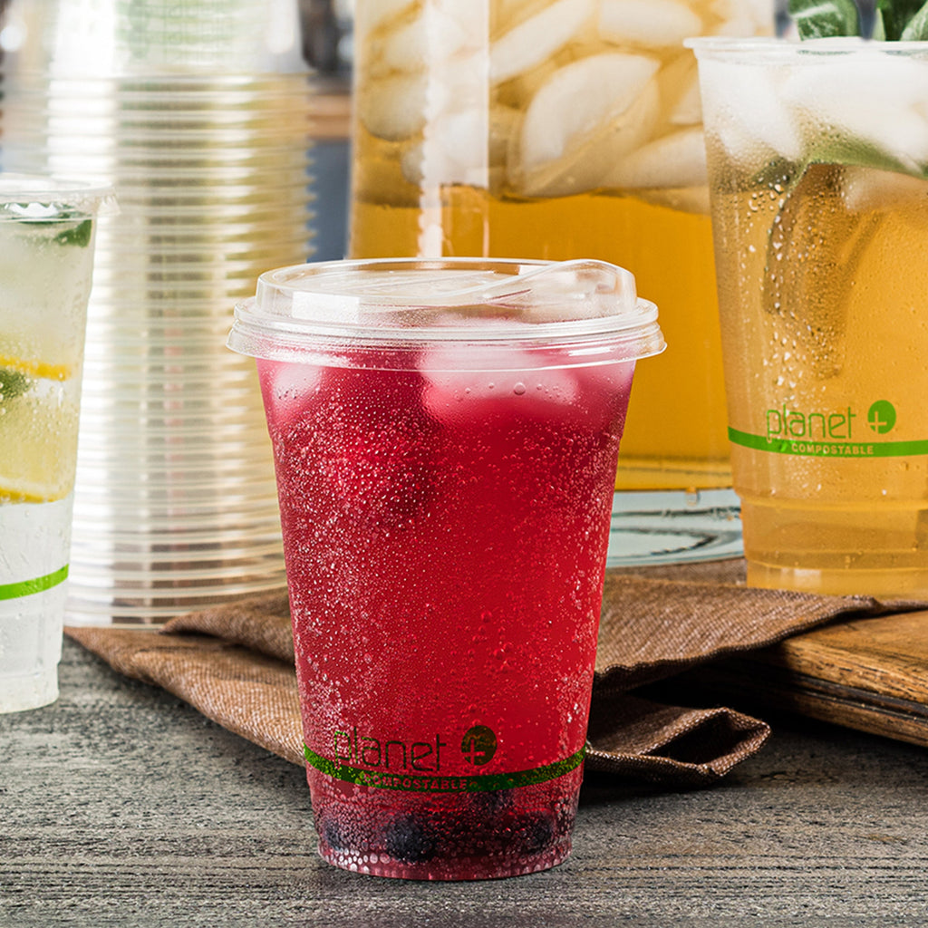 Red iced drink in a Planet cup with other drinks in the background