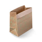 Brown paper waste bag with green leaf pattern on a white background