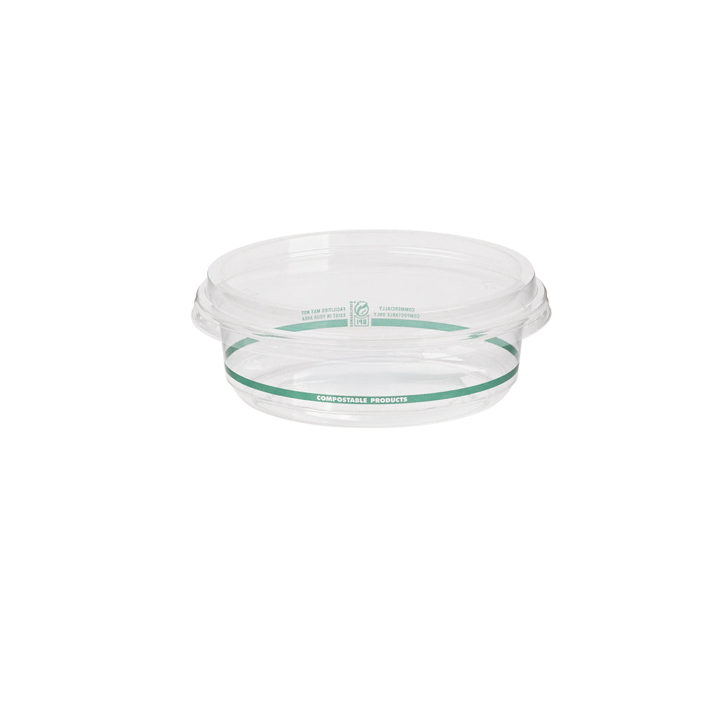 Clear deli bowl with green labels with a clear round lid on a white background
