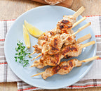 A plate containing pieces of chicken on 6 inch compostable skewers.