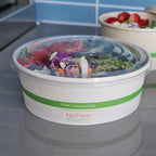 Salad in a compostable container with 'NoTree' branding on a kitchen counter.