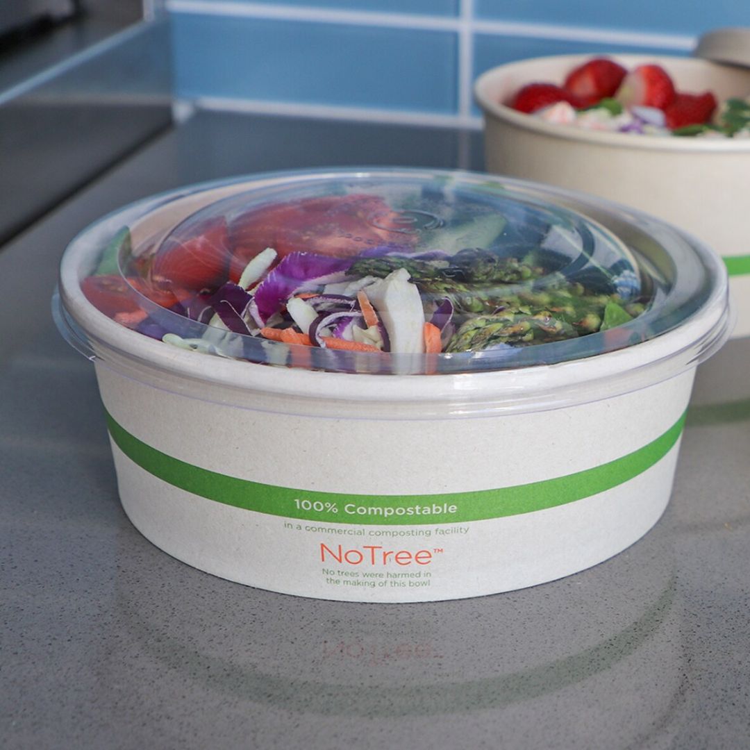 Salad in a compostable container with 'NoTree' branding on a kitchen counter.