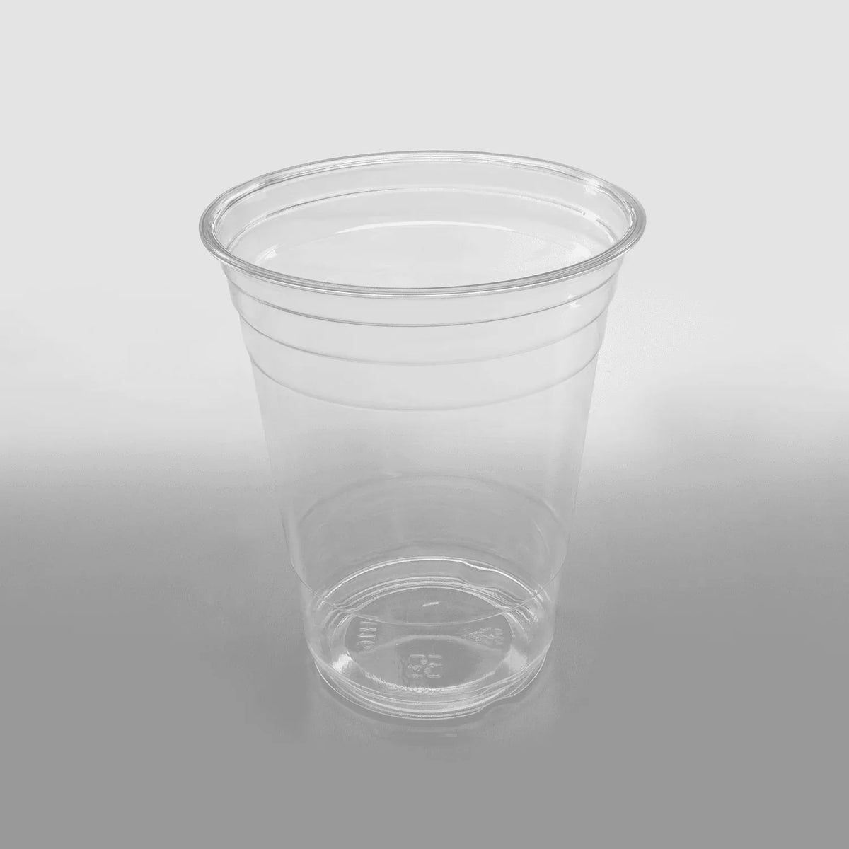 Clear plastic cup on a gray background