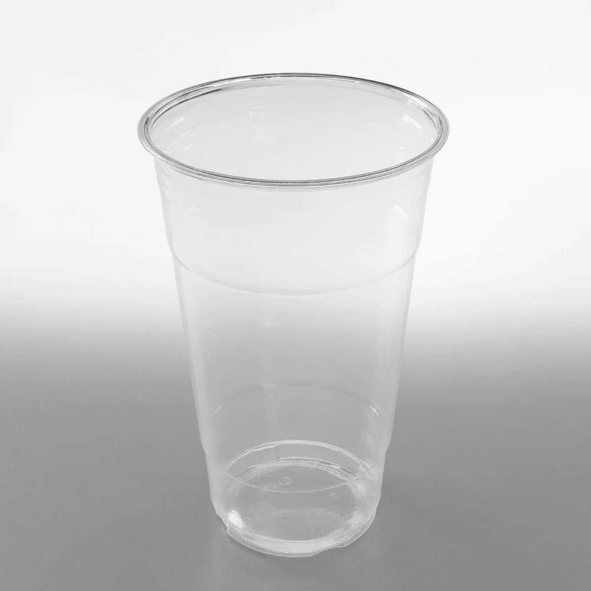 Clear plastic cup on a gray background