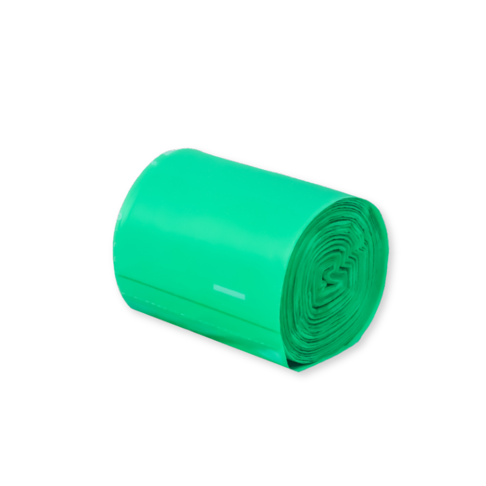 Roll of green home compostable bags on a white background