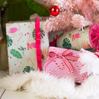 Gifts wrapped in eco-friendly paper with pink ribbon and red/white strip ribbon.