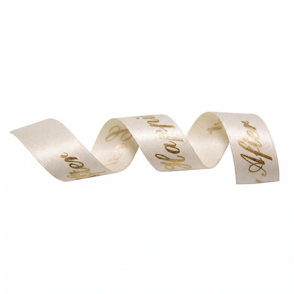 Cream ribbon with gold text on a white background