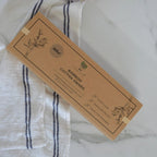 Box of Bamboo Cotton Swabs on a white and blue striped fabric background