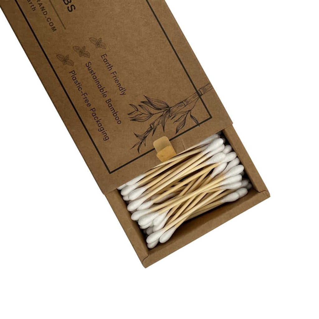 A box of reusable bamboo cotton swabs shown open on a white background, with the kraft-paper packaging and the white-tipped swabs arranged in the compartment.