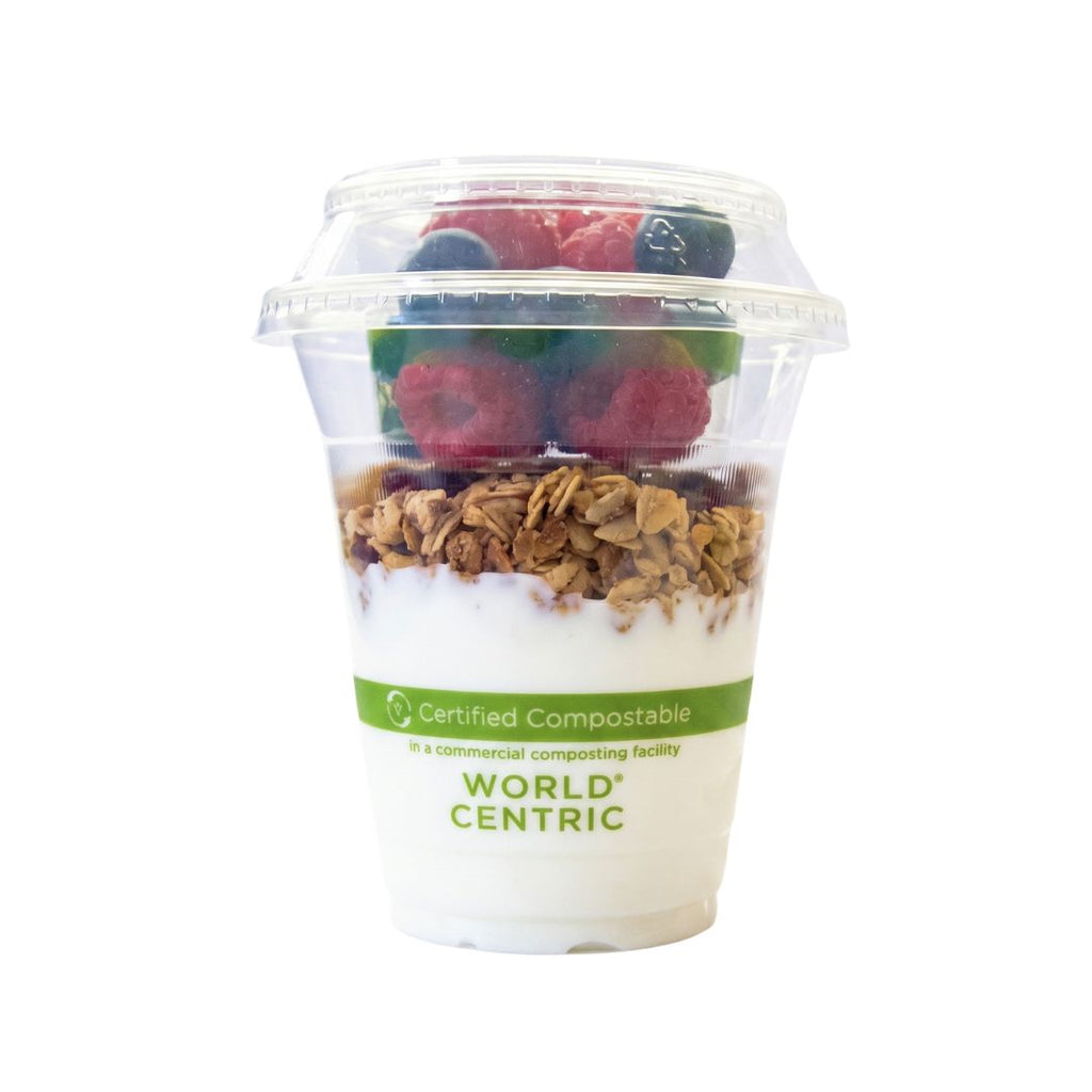 Yogurt with granola and berries in a World Centric compostable container on a white background