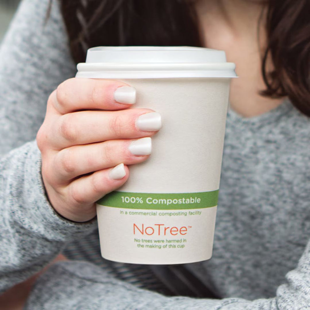 Hand holding a 100% compostable coffee cup with 'NoTree' branding.