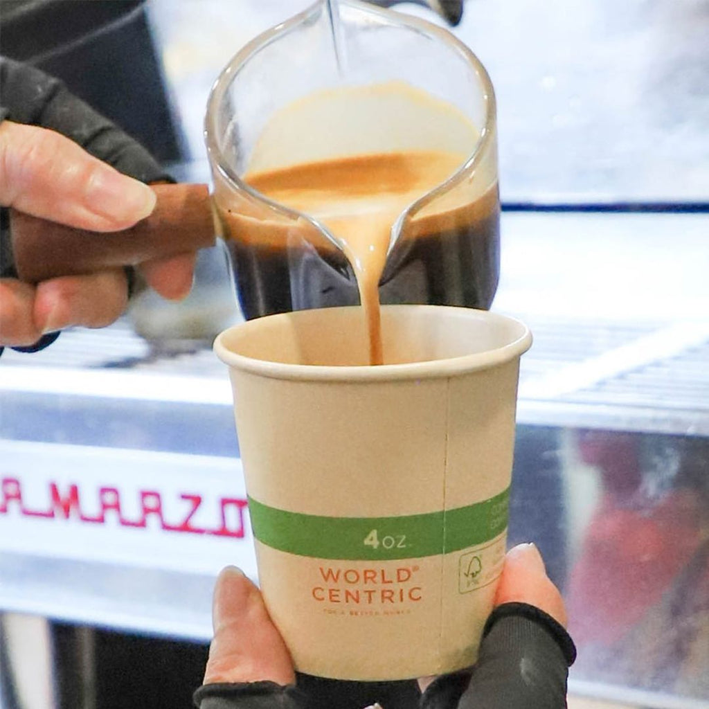 Coffee being poured into a World Centric paper cup.