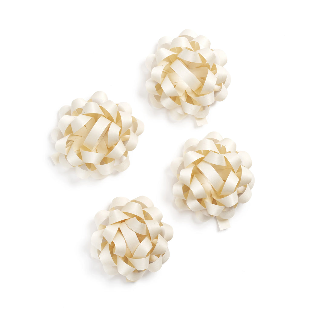 Four cream-colored ribbon loops on a white background