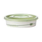 White food container with compostable green lid on a white background