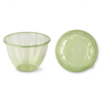 Green tinted salad bowl with a lid on a white background