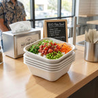 Stack of poke bowls in disposable bowls on a wooden counter with a sign in the background.