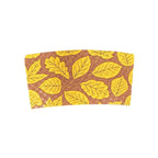 A compostable hot cup sleeve featuring a gold leaf pattern on a brown background, shown against a plain white backdrop.