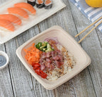 Poke served inside a disposable square bowl.