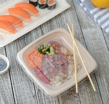 Top view of compostable fiber bowl with a clear plastic lid with chopsticks resting on top of the container.