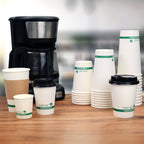 Coffee machine with compostable cups on a wooden surface