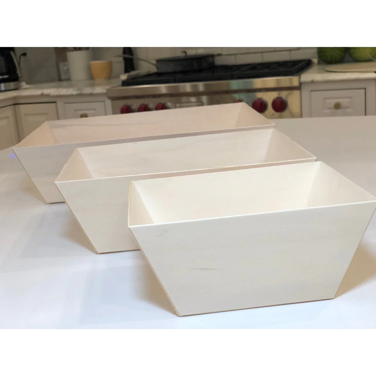 Set of three beige square trays on a kitchen counter