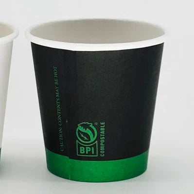 Black and green compostable paper cup on a white background