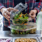Large clear clamshell and small clear clamshell stacked on top, filed with food at the salad bar.