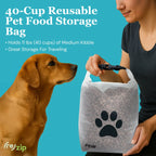 Person holding a 40-cup reusable pet food storage bag with a dog looking at it, on a blue background.