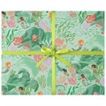 Wrapping paper with a mermaid and coral ocean-themed print, tied with a bright yellow-green ribbon and bow in the center.