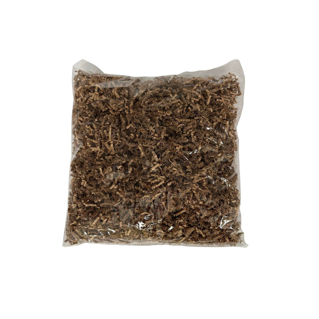 A clear plastic bag filled with shredded brown paper on a plain white background.