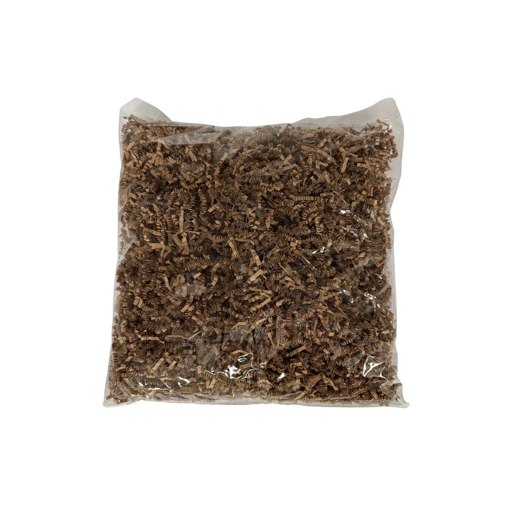 A clear plastic bag filled with shredded brown paper on a plain white background.