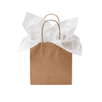 A brown kraft paper gift bag with two twisted paper handles, filled with crumpled white tissue paper, isolated on a white background.