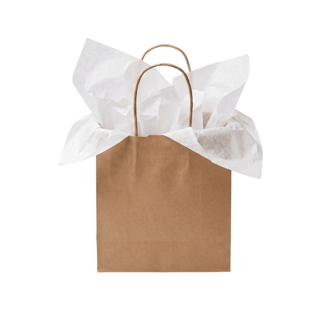 A brown kraft paper gift bag with two twisted paper handles, filled with crumpled white tissue paper, isolated on a white background.