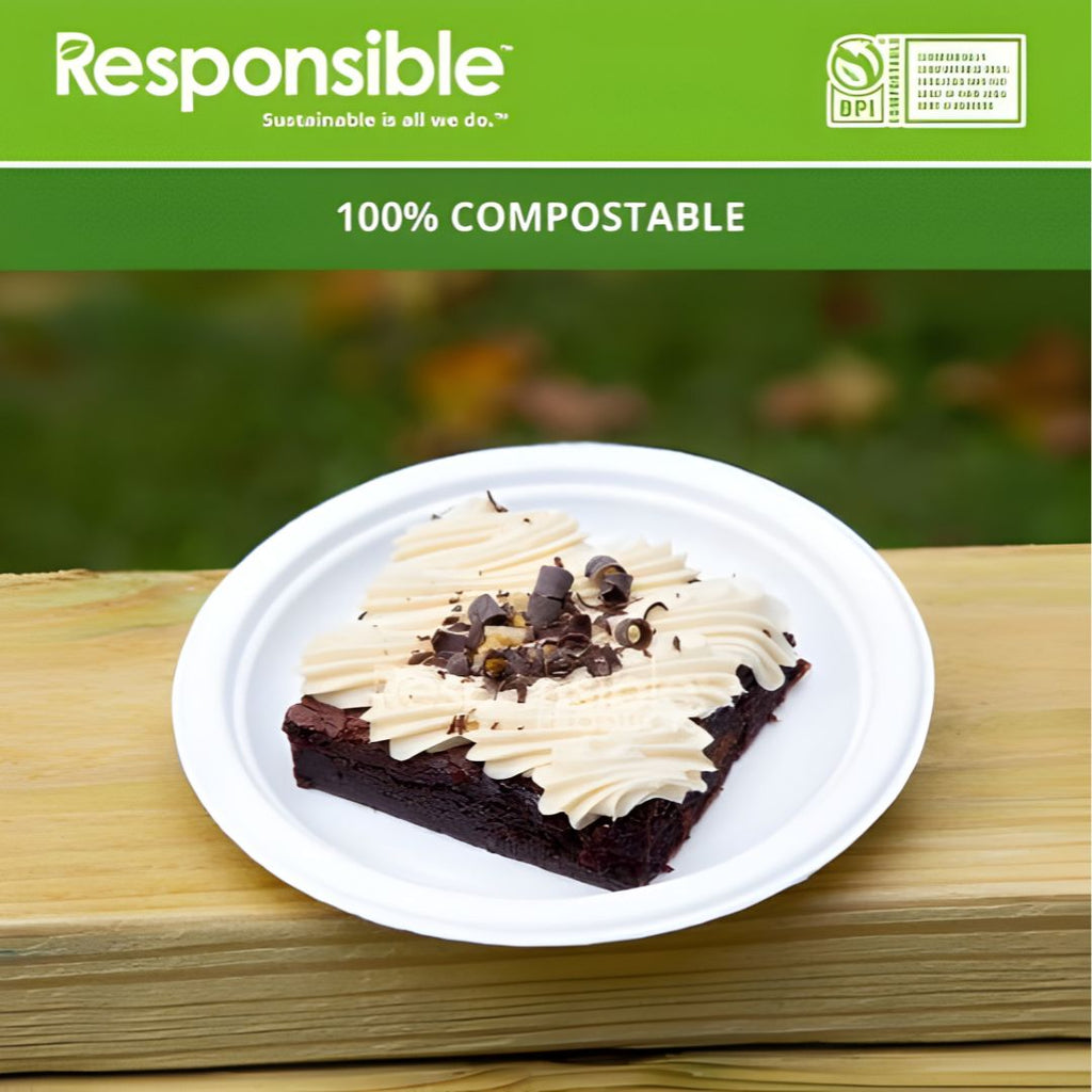 Brownie with cream on a compostable plate against a green background