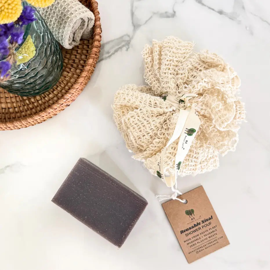 Washable shower pouf with a tag on a marble surface