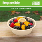 Fruit salad in a tan bowl on a wooden table.