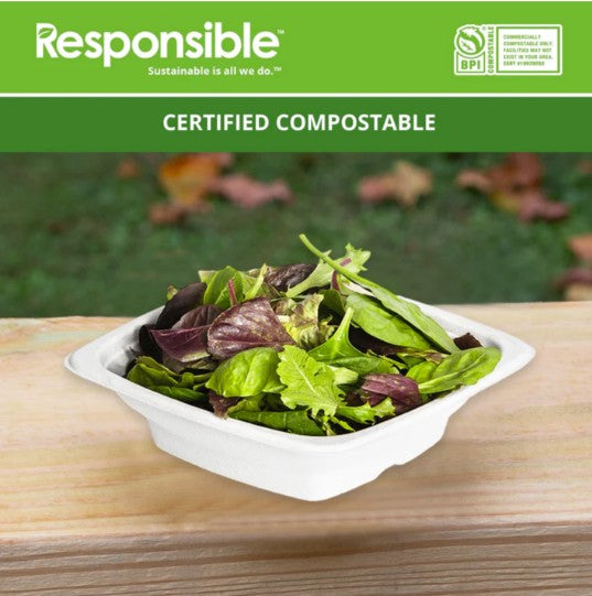 Square white bowl filled with salad sitting on a wooden surface.