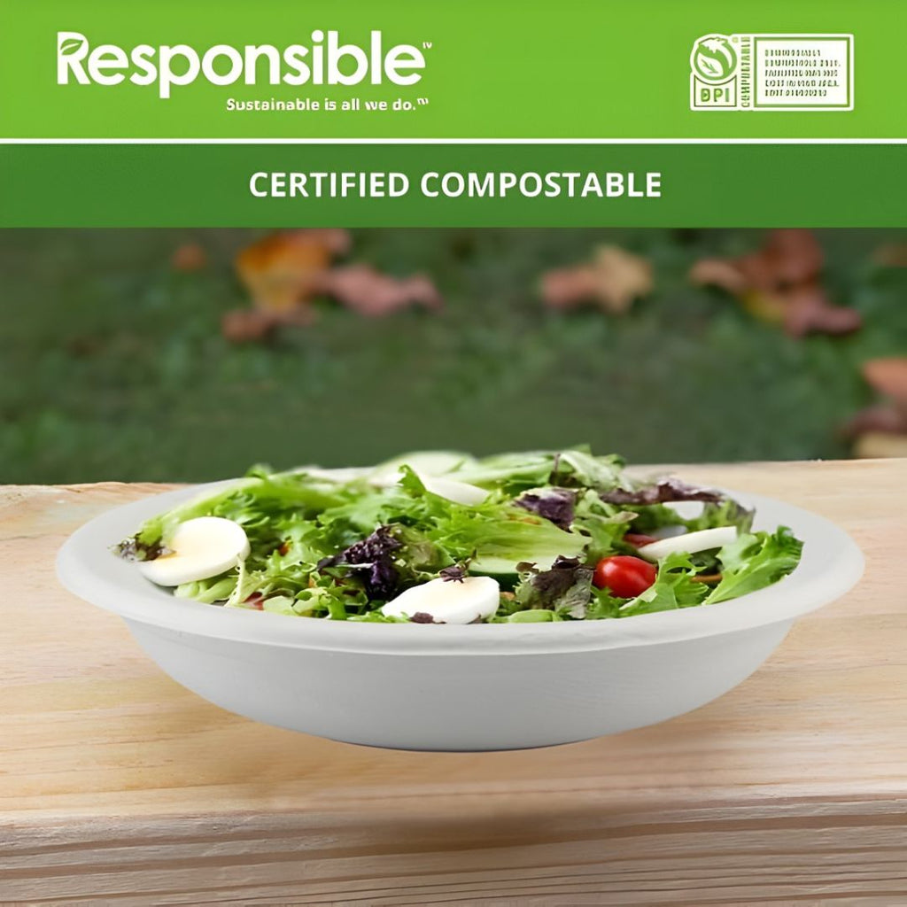 Disposable bowl of salad on a wooden table with 'Responsible' branding and compostable certification label.