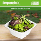 Compostable square bowl filled with lettuce on top of a wooden surface.