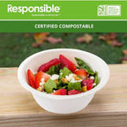 Bowl of salad with strawberries on a wooden surface, branded as 'Responsible' for compostability.