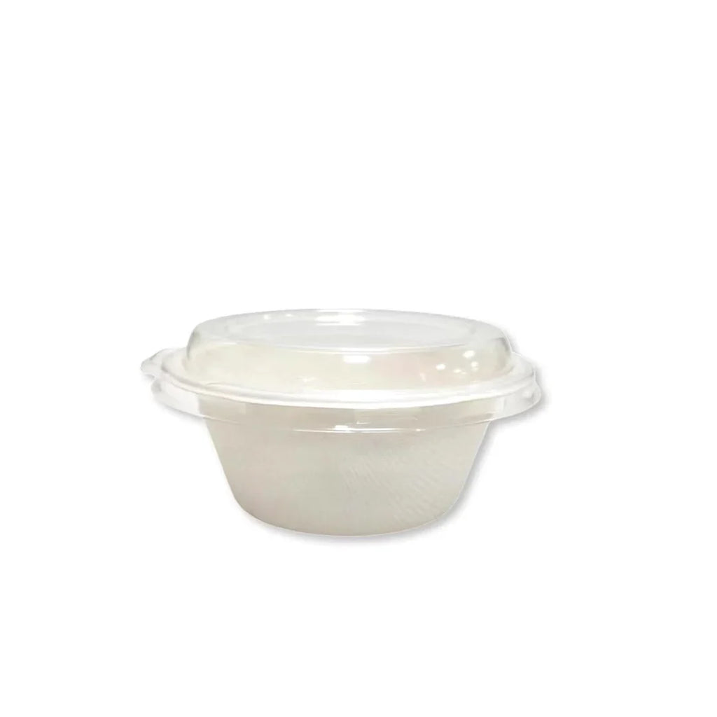 Clear plastic lid on a white compostable bowl on a white background
