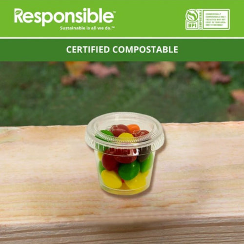 Certified compostable container with candy on a wooden surface, branded 'Responsible'.