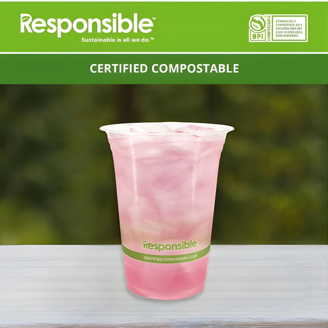 Certified compostable pink cup with 'Responsible' branding on a blurred green background