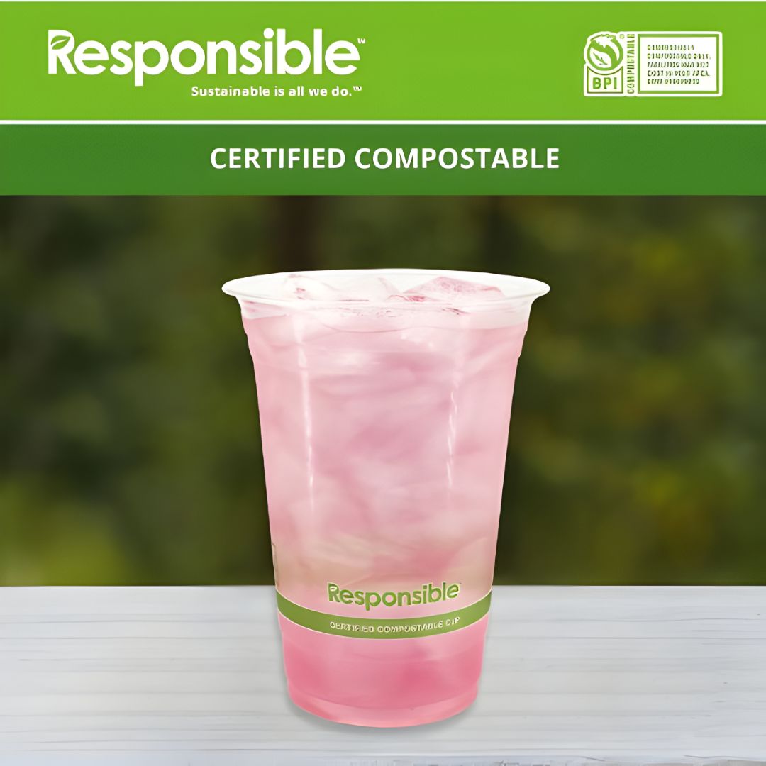 Certified compostable pink drink cup with 'Responsible' branding on a blurred green background