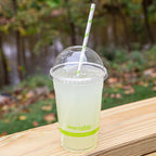 Lemonade in a compostable cup with a dome lid and straw with 'Responsible' branding on a green background
