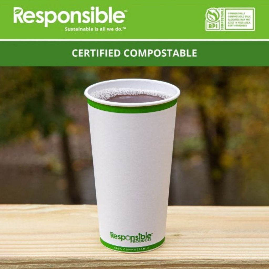 Compostable cup with a green rim and 'Responsible' branding on a wooden surface.