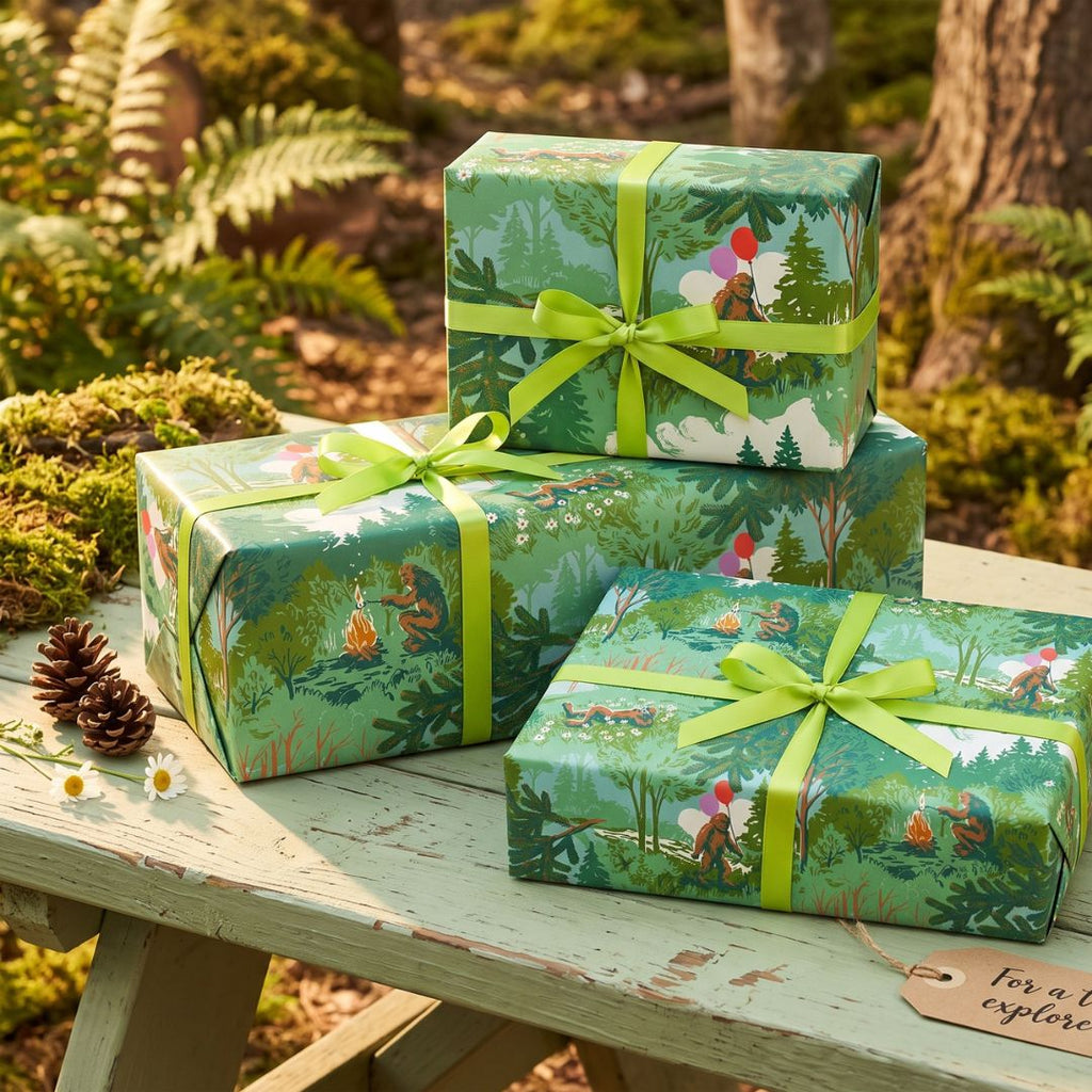 3 Gifts wrapped in sasquatch gift wrap with bowls on a woodsy background.