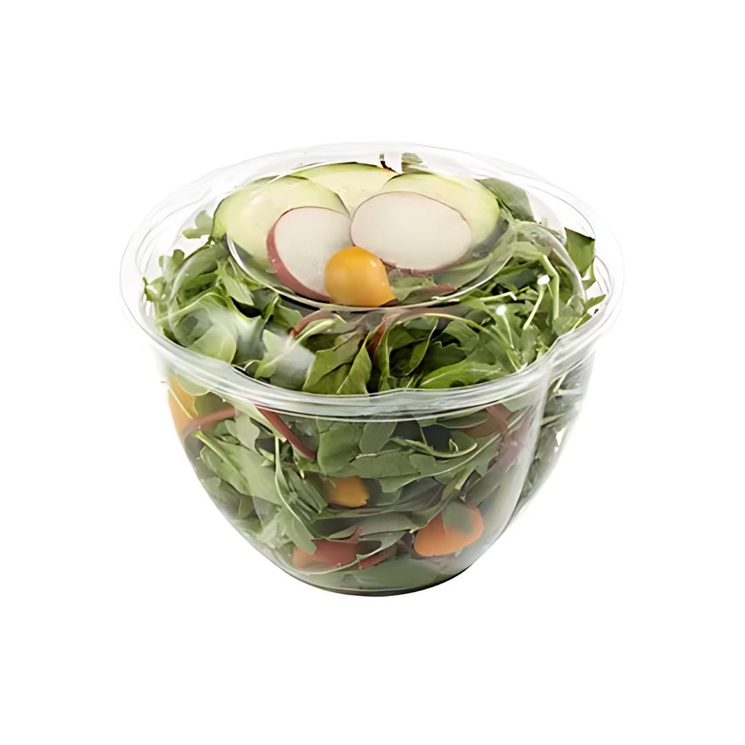 Clear compostable salad bow lwith a lid containing greens, radishes, and cherry tomatoes on a white background