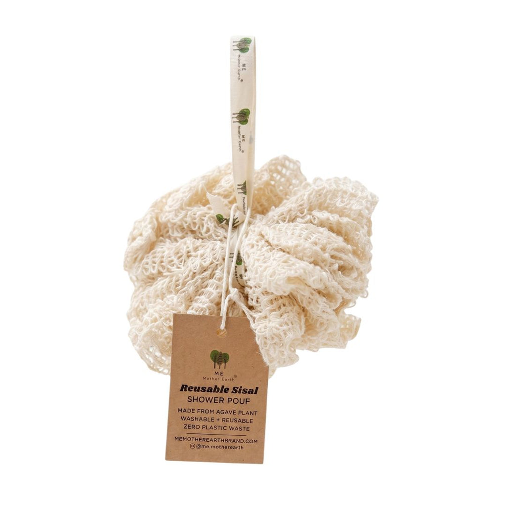 A reusable sisal shower pouf made from natural beige sisal fiber, featuring a hanging kraft paper tag and a cotton handle printed with green leaf illustrations.